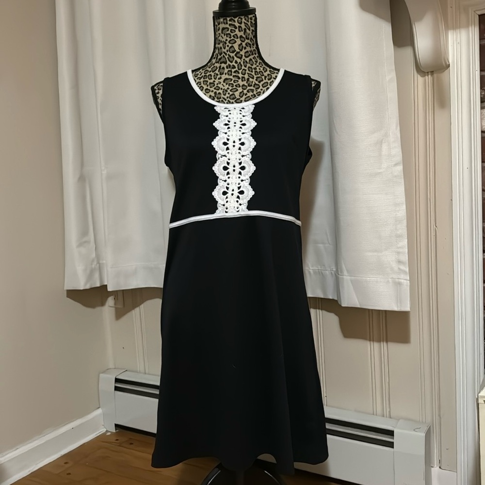 Sleeveless black dress with white lace detail
